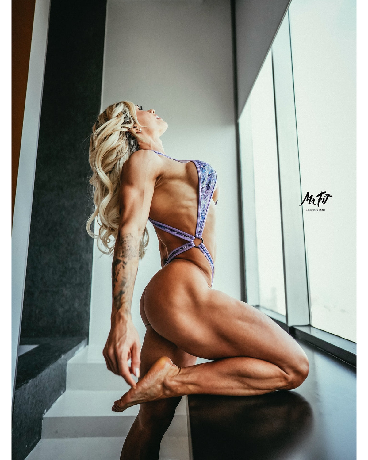 Barely there criss cross one-piece limited edition, model Giselle Machado side view. American-made, manufactured in Clearwater Florida
